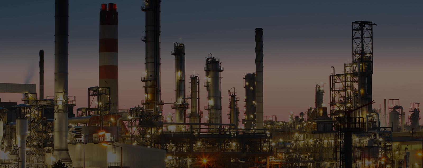 oil and gas refinery at sunset